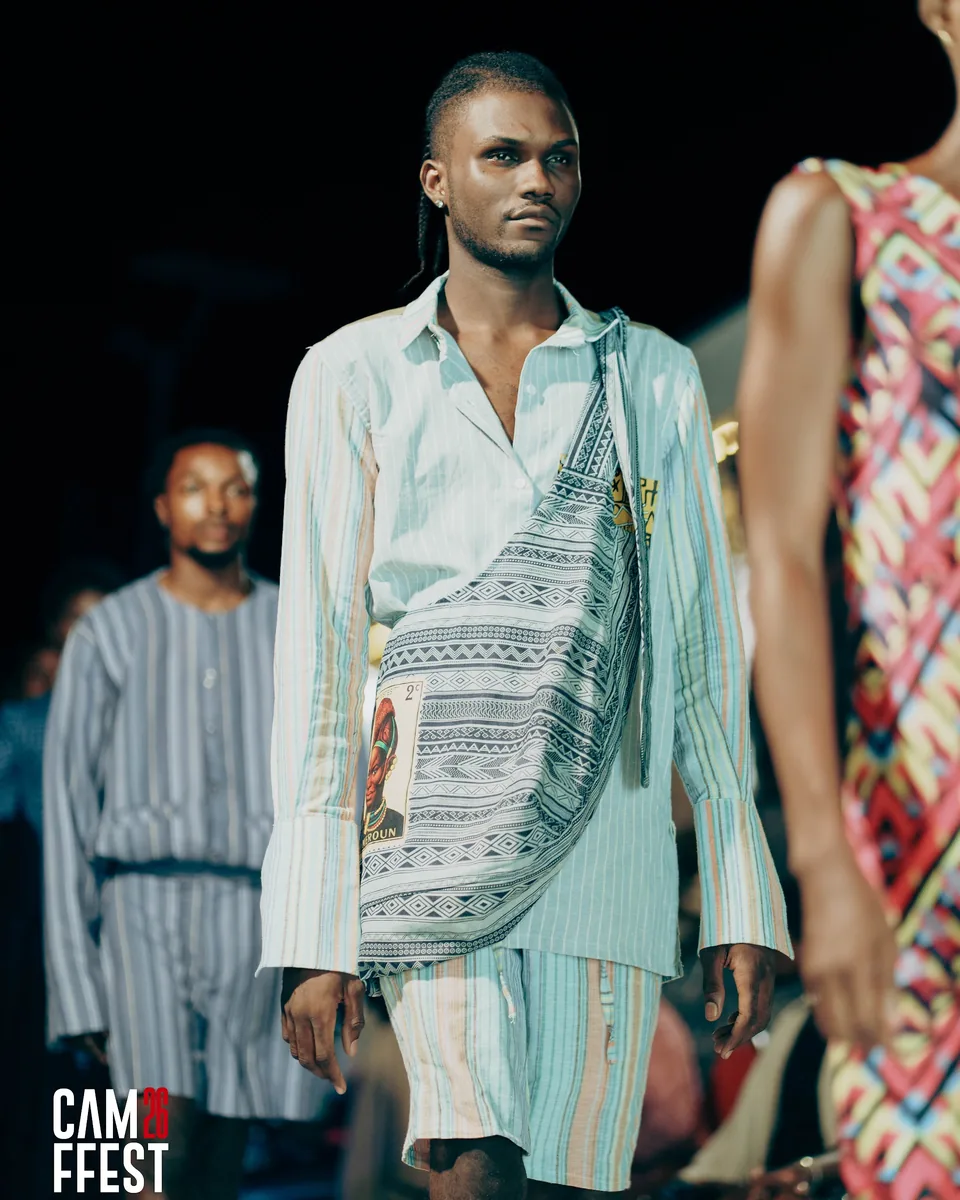 Model in a pale shirt and printed wrap