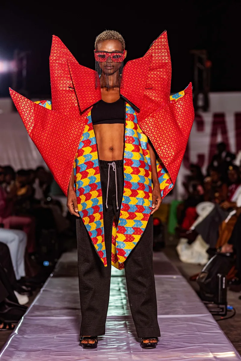 Model in a red winged kente look