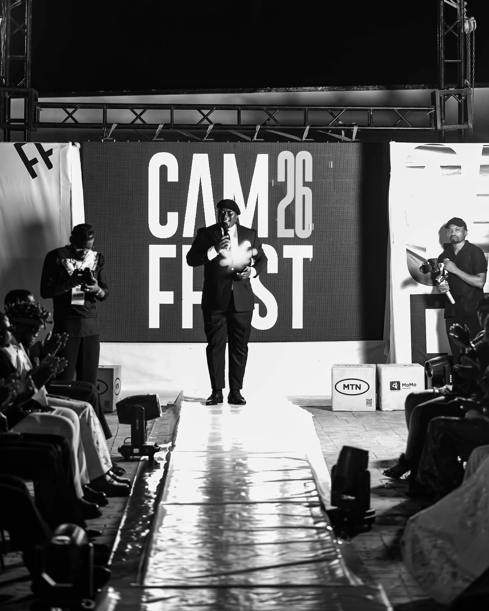 The CAMFFEST 2026 stage and runway, in black and white