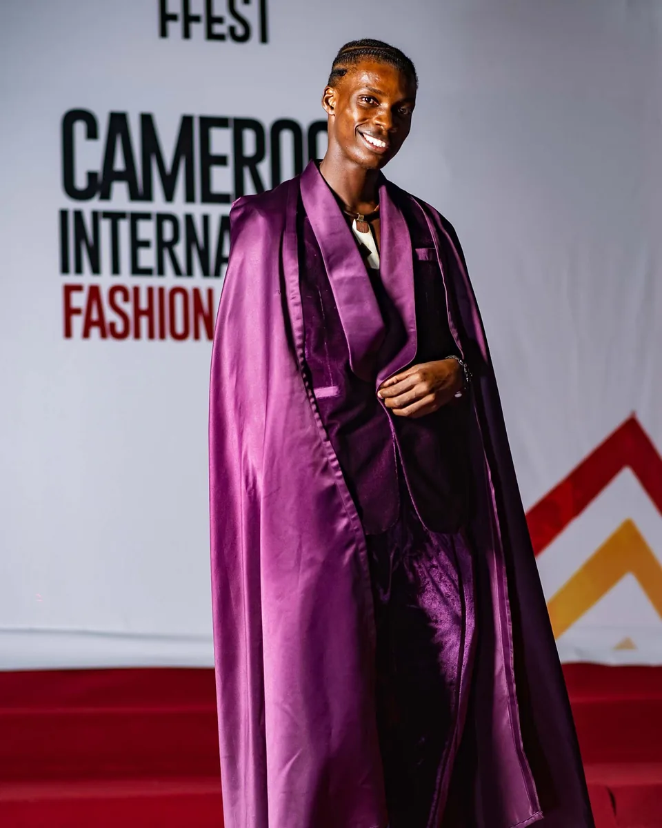 Guest in a flowing purple cape on the red carpet