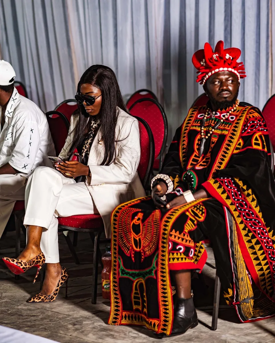 VIP guests in the front row, one in royal dress