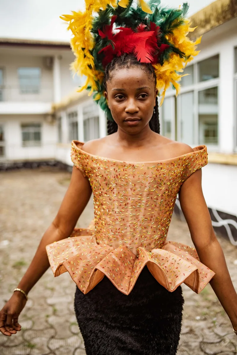 Model in a copper peplum corset and floral headpiece